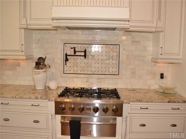 9009 Albatross Court Raleigh, NC 27613 - Photo 5 of 25 a stove top oven sitting inside of a kitchen