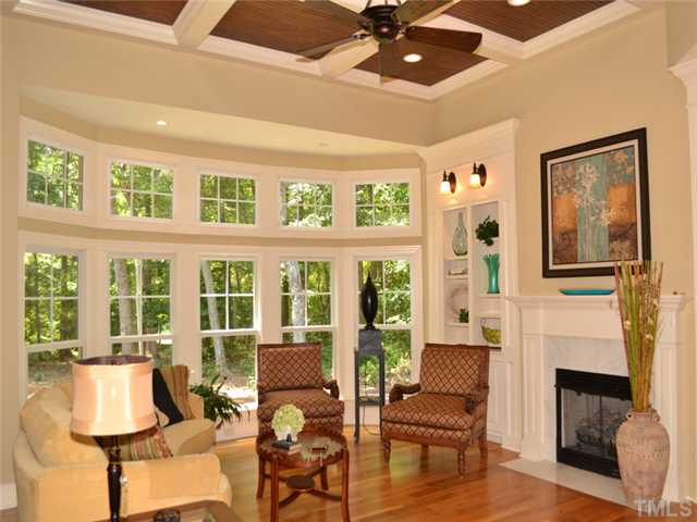 9009 Albatross Court Raleigh, NC 27613 - Photo 7 of 25 a living room with furniture a fireplace and a flat screen tv