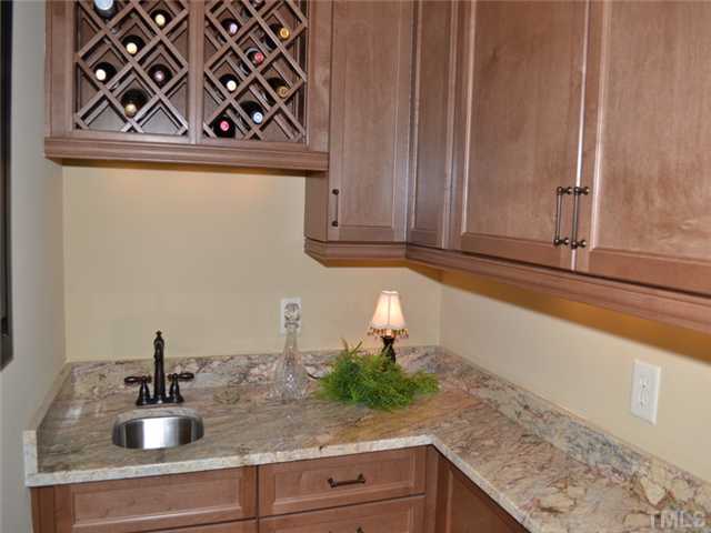9009 Albatross Court Raleigh, NC 27613 - Photo 9 of 25 a kitchen with a sink and cabinets