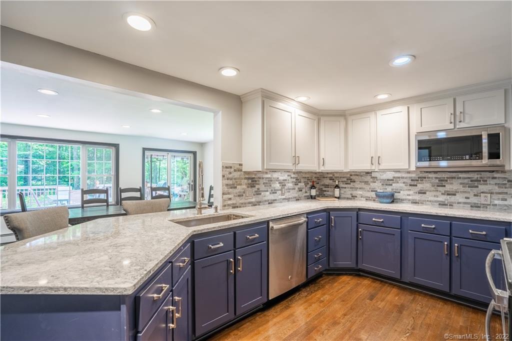 a kitchen with granite countertop sink stove and cabinets