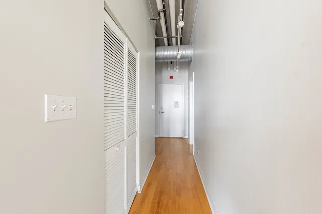 a view of a hallway with wooden floor