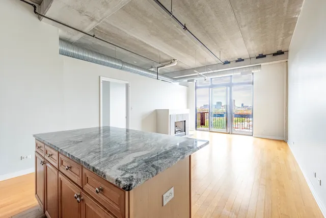 a kitchen with kitchen island a counter top a sink and stove