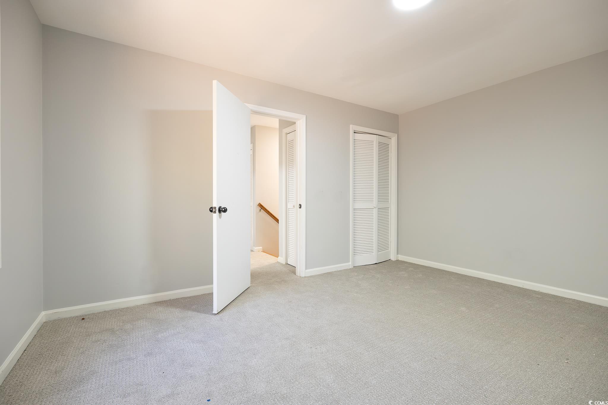 117 George Washington Trail Georgetown, SC 29440 - Photo 12 of 30 Unfurnished bedroom with multiple closets and light carpet