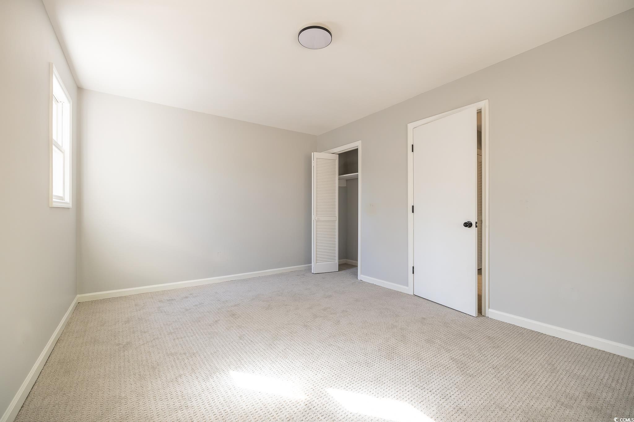 117 George Washington Trail Georgetown, SC 29440 - Photo 14 of 30 Unfurnished bedroom with light colored carpet and a closet