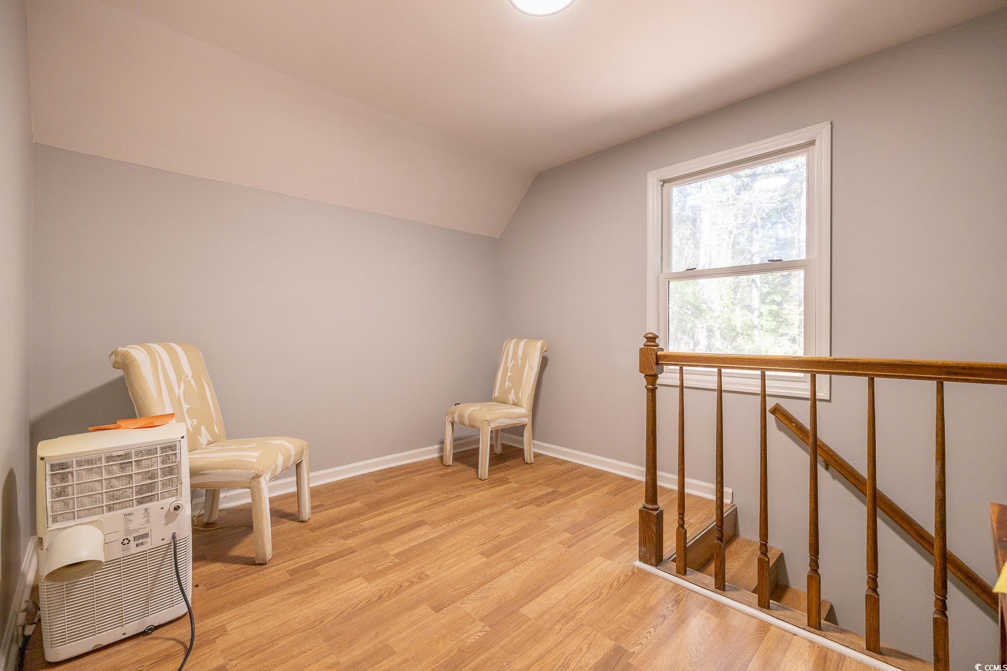 117 George Washington Trail Georgetown, SC 29440 - Photo 18 of 30 Living area with vaulted ceiling and light wood-type flooring