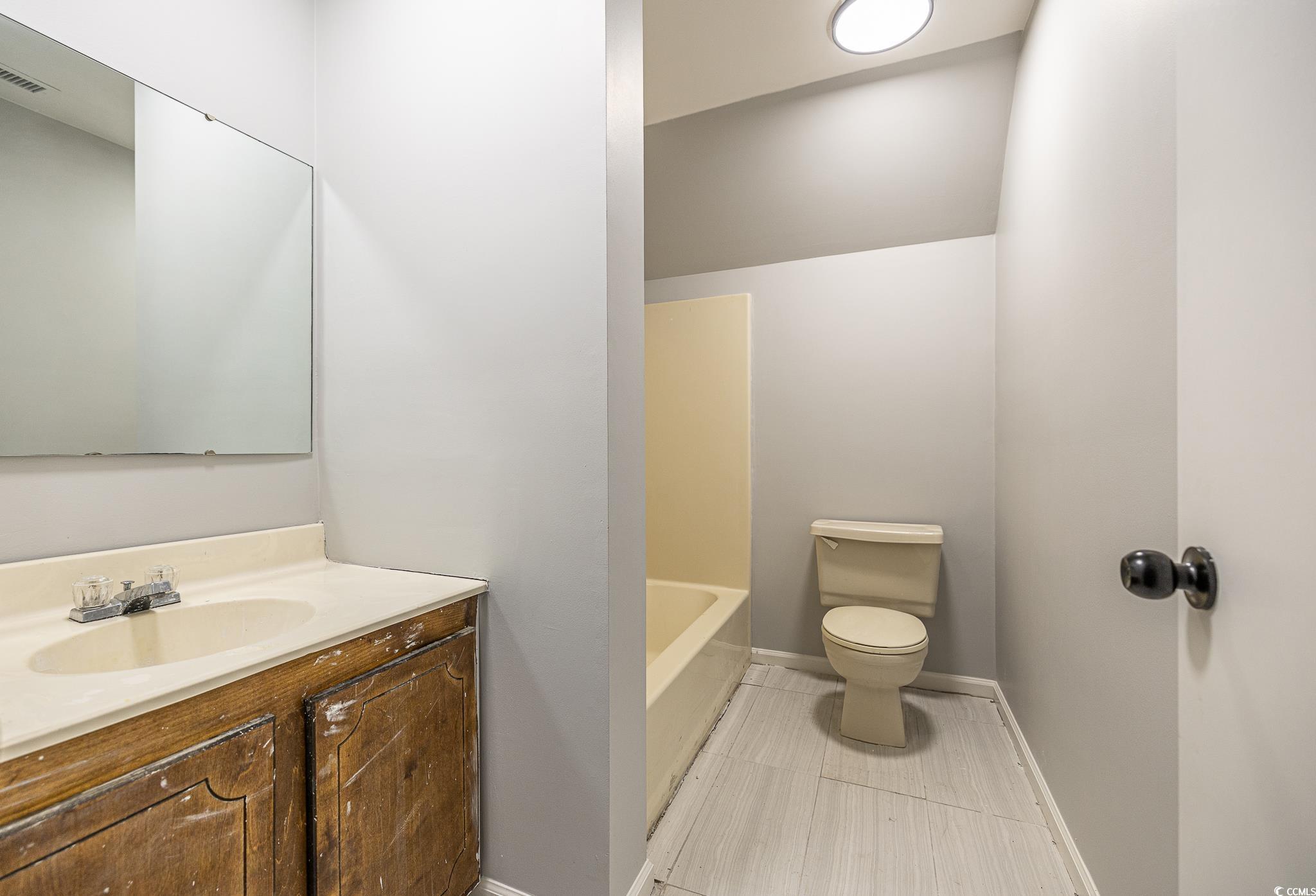117 George Washington Trail Georgetown, SC 29440 - Photo 19 of 30 Bathroom featuring toilet, vanity, and a tub to relax in