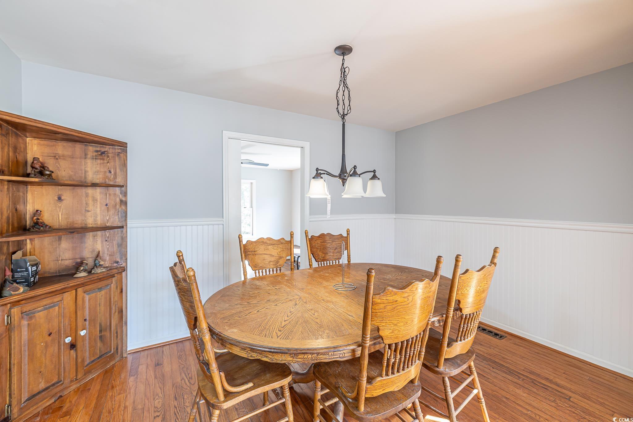 117 George Washington Trail Georgetown, SC 29440 - Photo 24 of 30 Dining area featuring a chandelier and hardwood / wood-style floors
