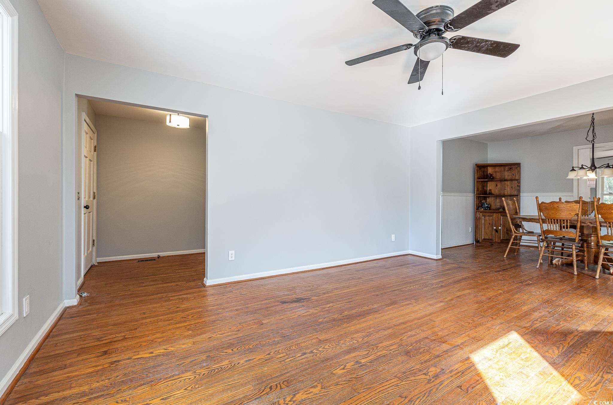 117 George Washington Trail Georgetown, SC 29440 - Photo 25 of 30 Unfurnished living room featuring ceiling fan and dark hardwood / wood-style floors