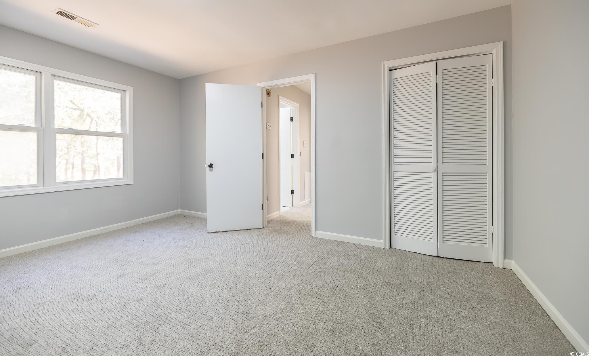 117 George Washington Trail Georgetown, SC 29440 - Photo 10 of 30 Unfurnished bedroom with light carpet and a closet
