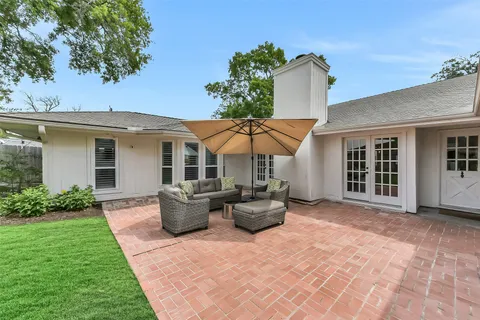 a backyard of a house with yard barbeque oven and outdoor seating