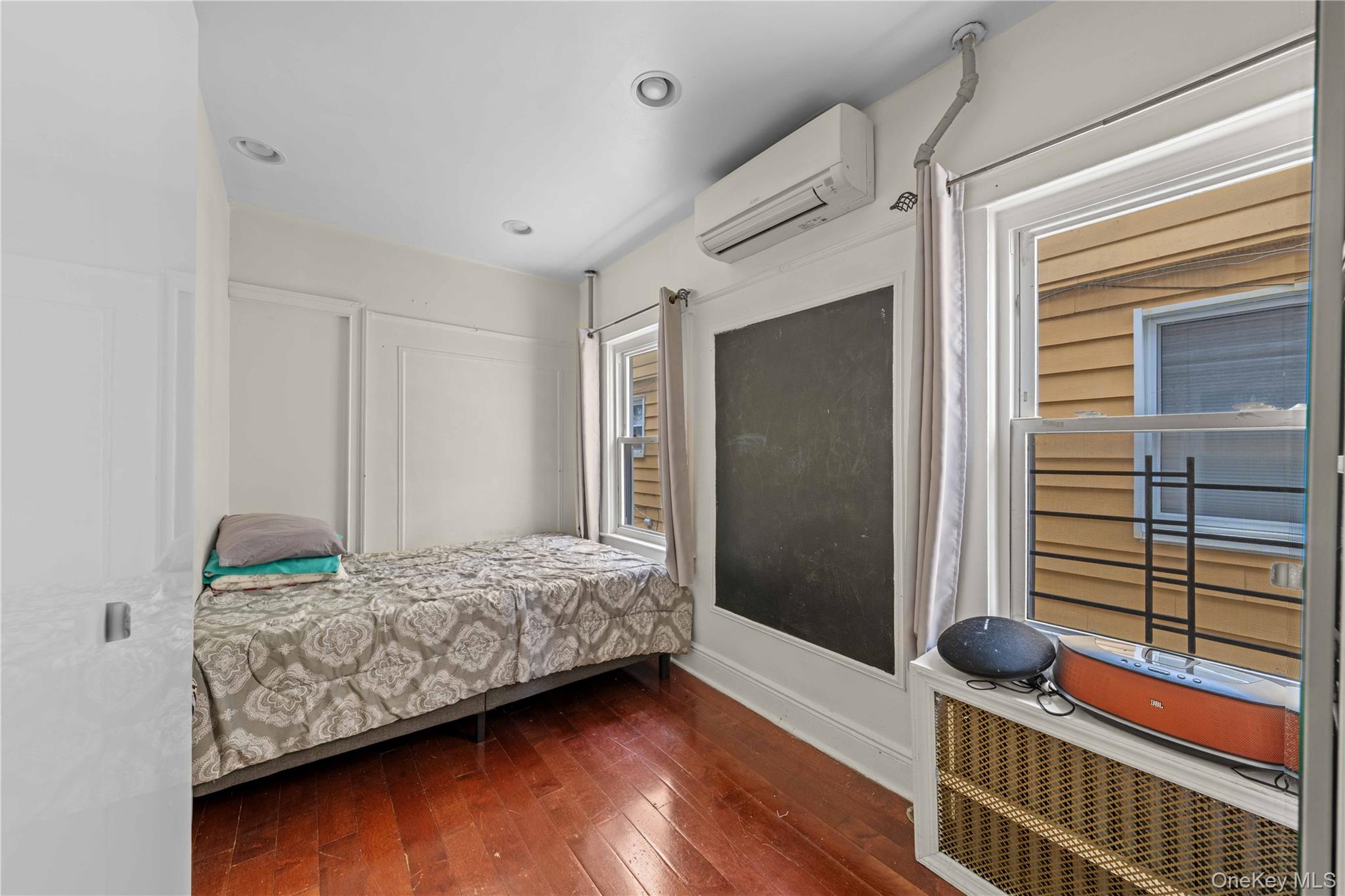 89-13 85th Street Queens, NY 11421 - Photo 11 of 15 Bedroom with radiator heating unit, dark wood-style flooring, a wall unit AC, and recessed lighting