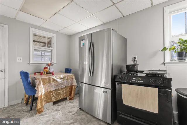 a kitchen with stainless steel appliances granite countertop a refrigerator and a stove