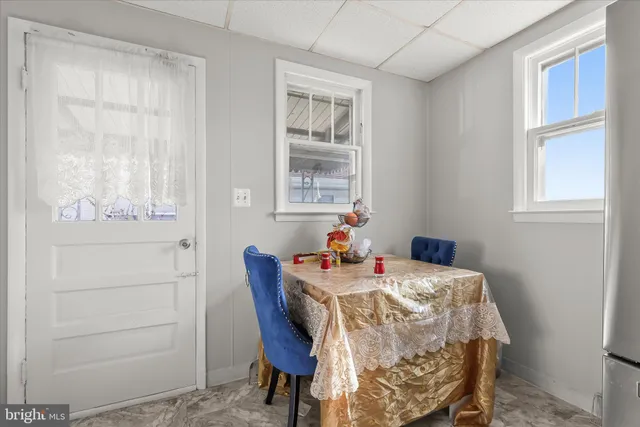 a view of a dining room with furniture and a window