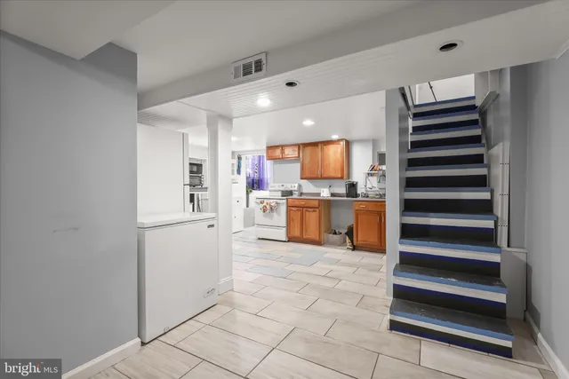 a kitchen with stainless steel appliances cabinets and an empty refrigerator