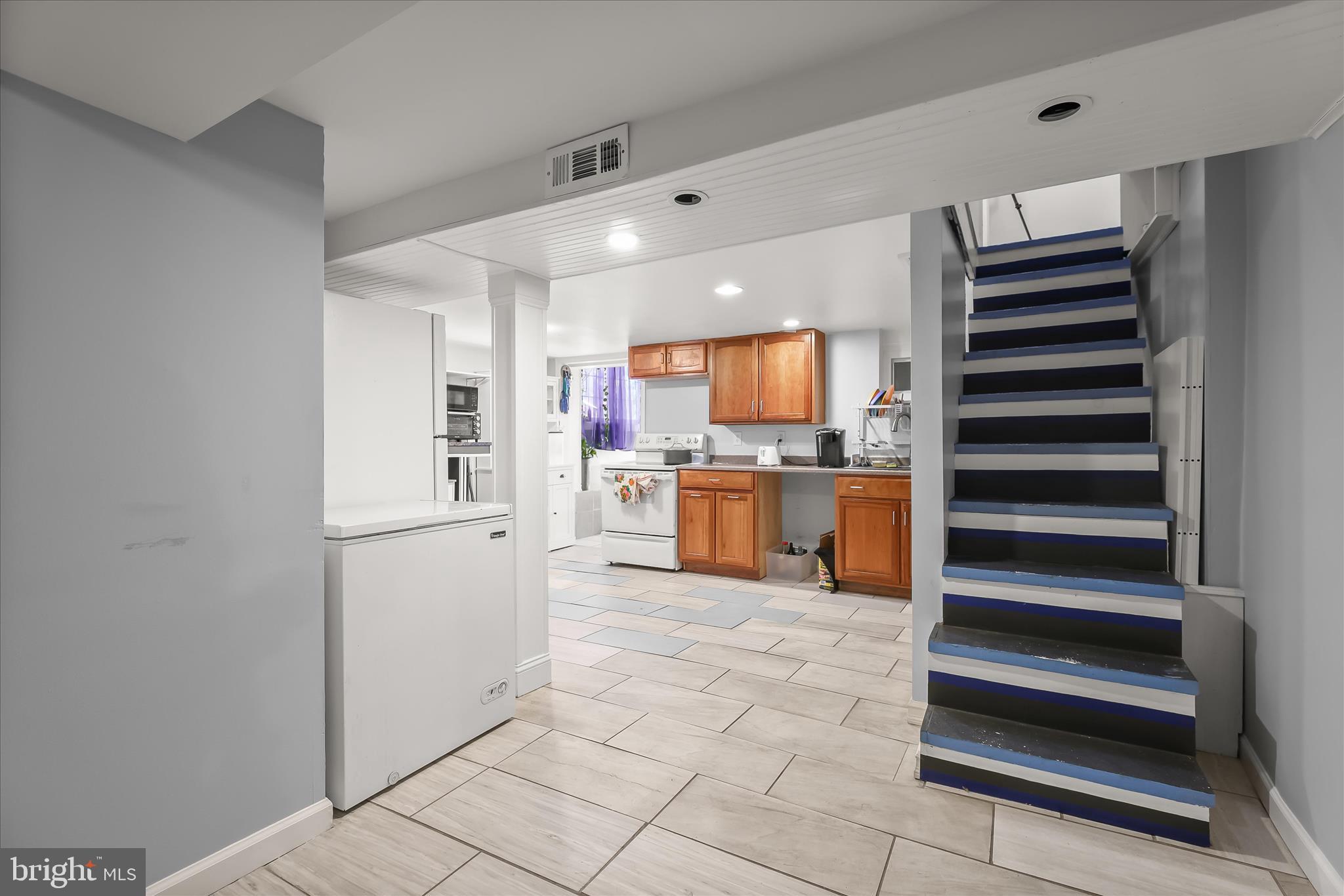 2813 Oak Grove Avenue Halethorpe, MD 21227 - Photo 13 of 43 a kitchen with stainless steel appliances cabinets and an empty refrigerator