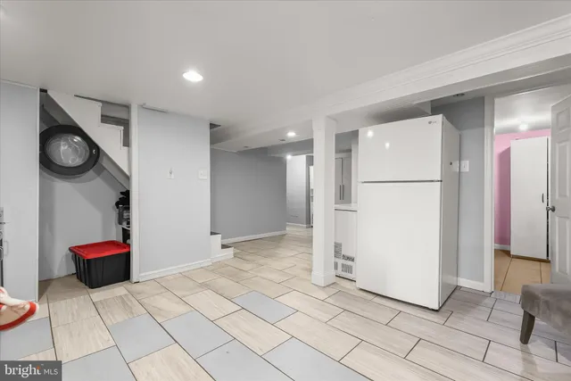 a view of an empty room and kitchen view