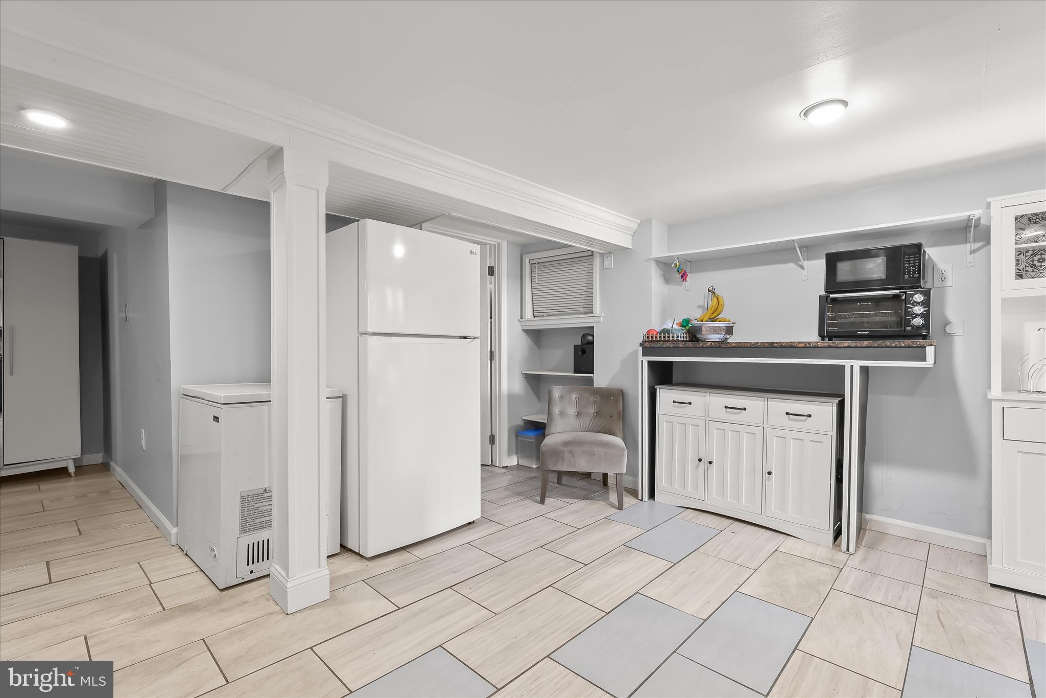 2813 Oak Grove Avenue Halethorpe, MD 21227 - Photo 15 of 43 a kitchen with white cabinets and appliances