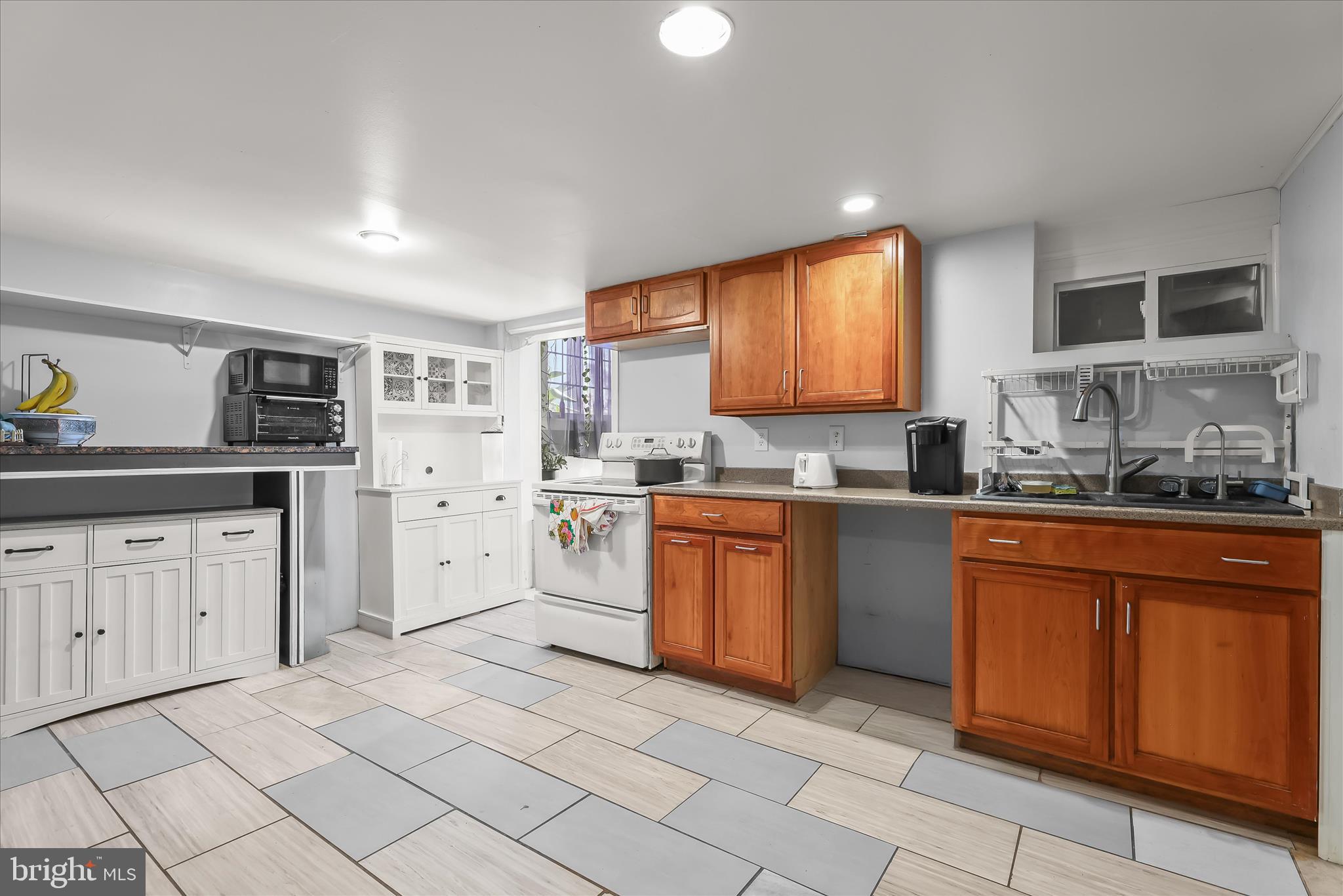 2813 Oak Grove Avenue Halethorpe, MD 21227 - Photo 16 of 43 a kitchen with cabinets appliances and a window