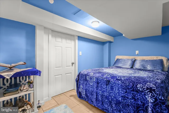 a bedroom with bed and mirror