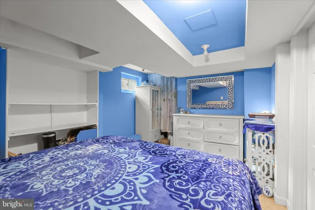 a bedroom with a bed and a dresser in it