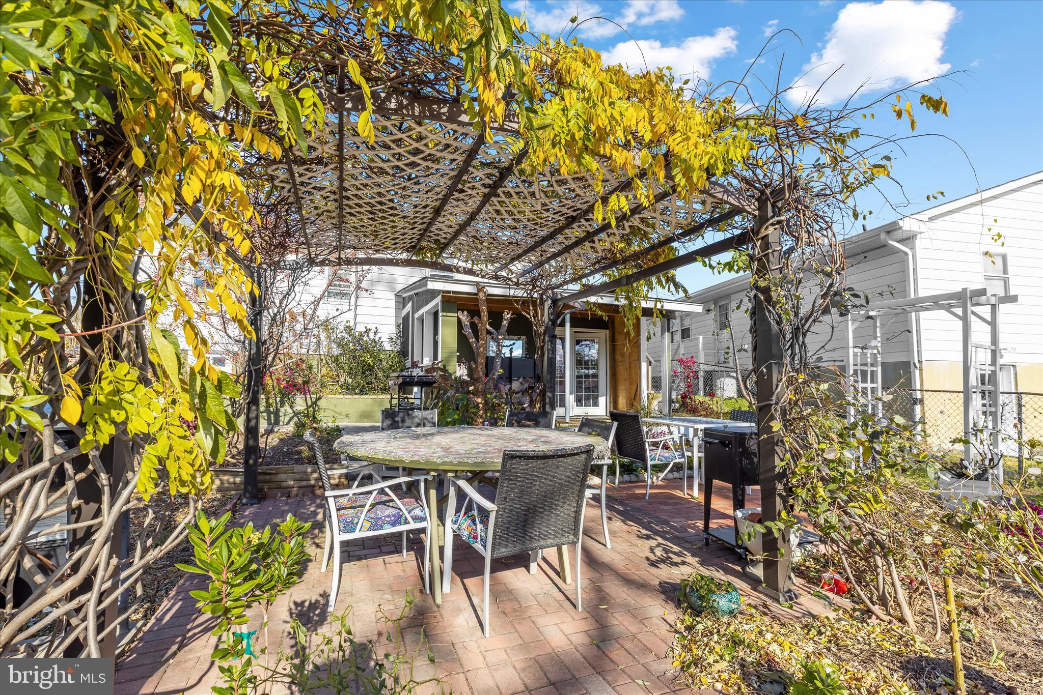 2813 Oak Grove Avenue Halethorpe, MD 21227 - Photo 25 of 43 a patio with table and chairs and potted plants