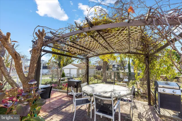 a view of a patio with table and chairs and potted plants