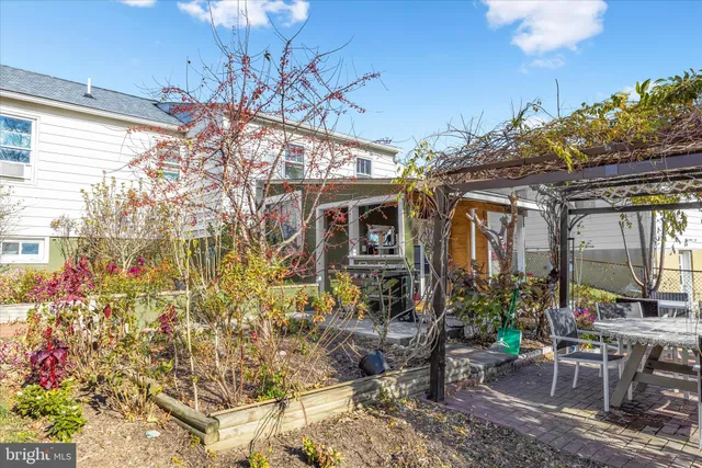 a view of a patio with table and chairs and potted plants