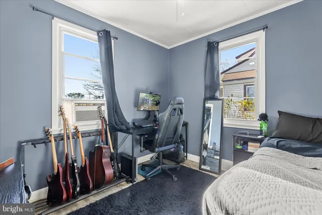 a bedroom with furniture and a window