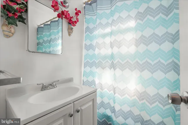 a bathroom with a sink mirror and vanity