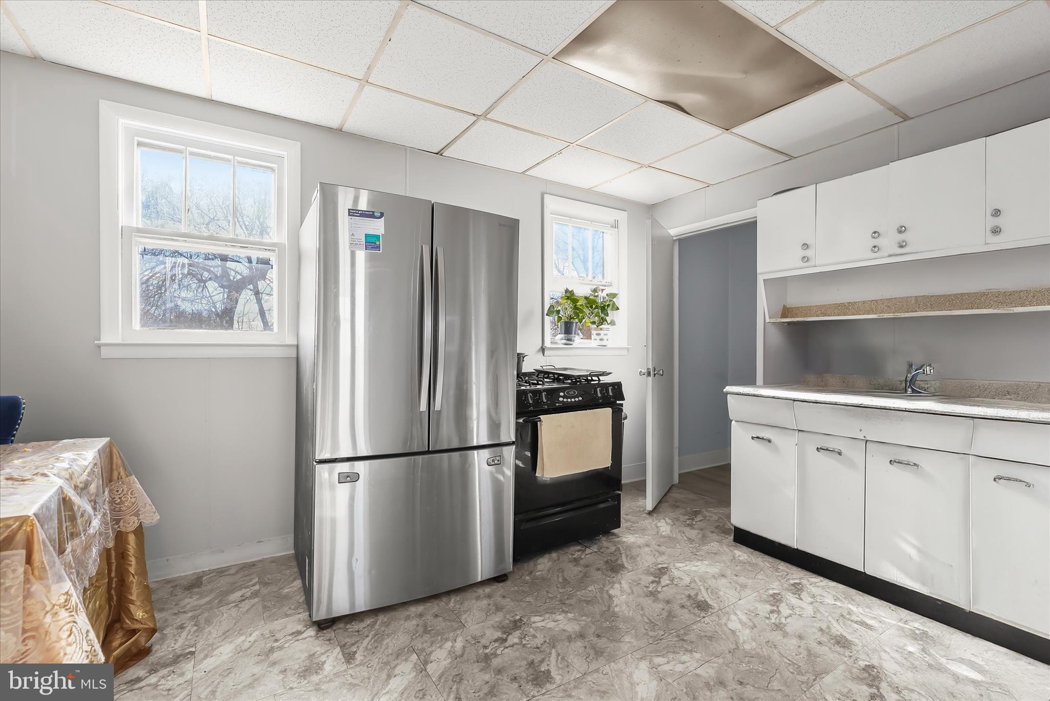 2813 Oak Grove Avenue Halethorpe, MD 21227 - Photo 9 of 43 a kitchen with a refrigerator sink and cabinets