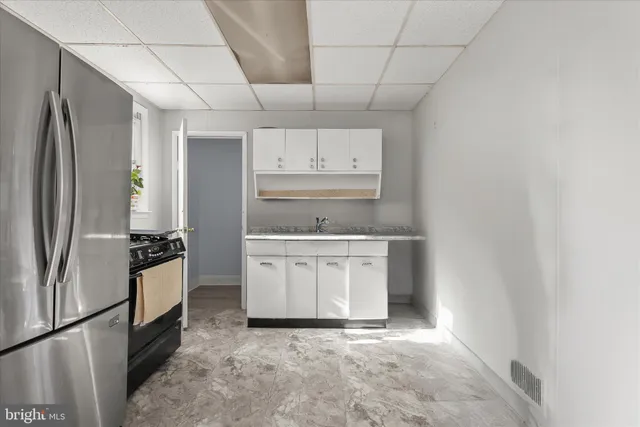 a kitchen with a refrigerator sink and stove