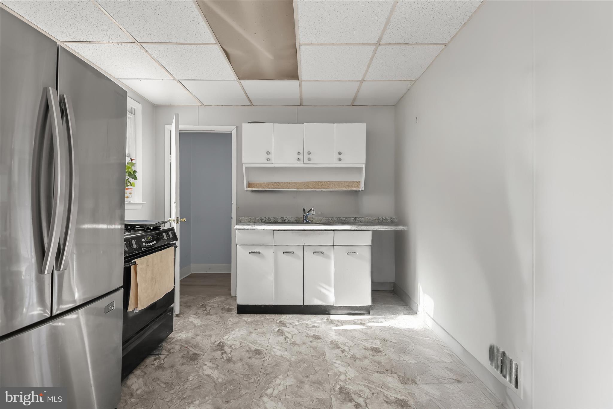 2813 Oak Grove Avenue Halethorpe, MD 21227 - Photo 10 of 43 a kitchen with a refrigerator sink and stove