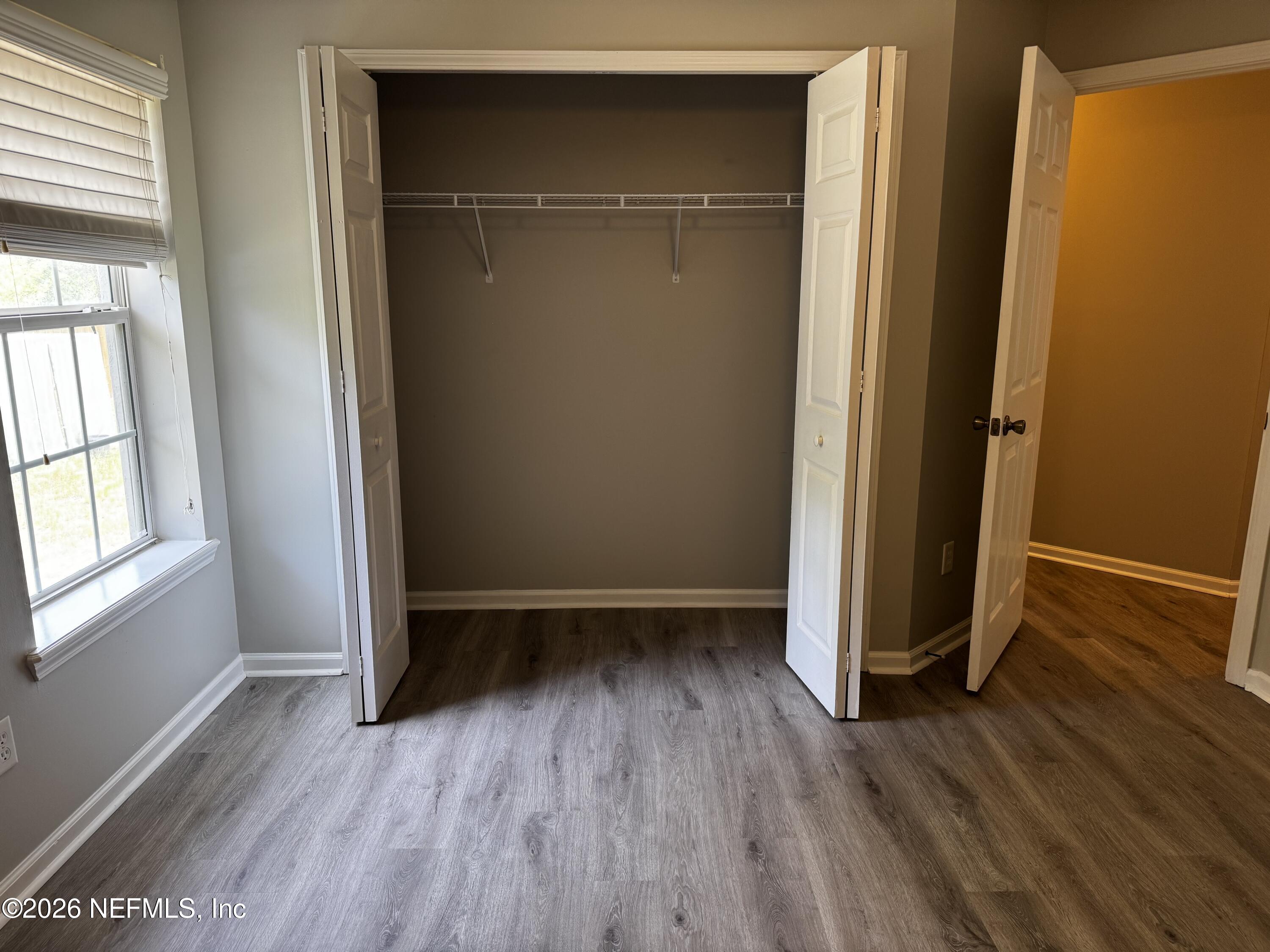 16255 Shellcracker Road Jacksonville, FL 32226 - Photo 24 of 40 an empty room with wooden floor and entrance