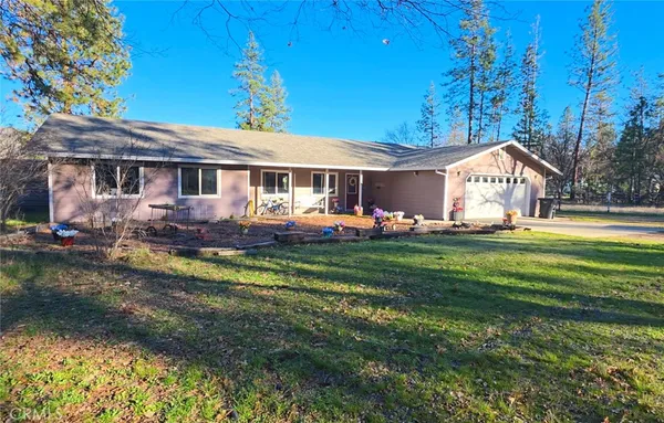 a front view of house with yard and seating area