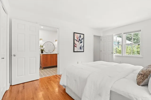 a bedroom with a large bed and a window