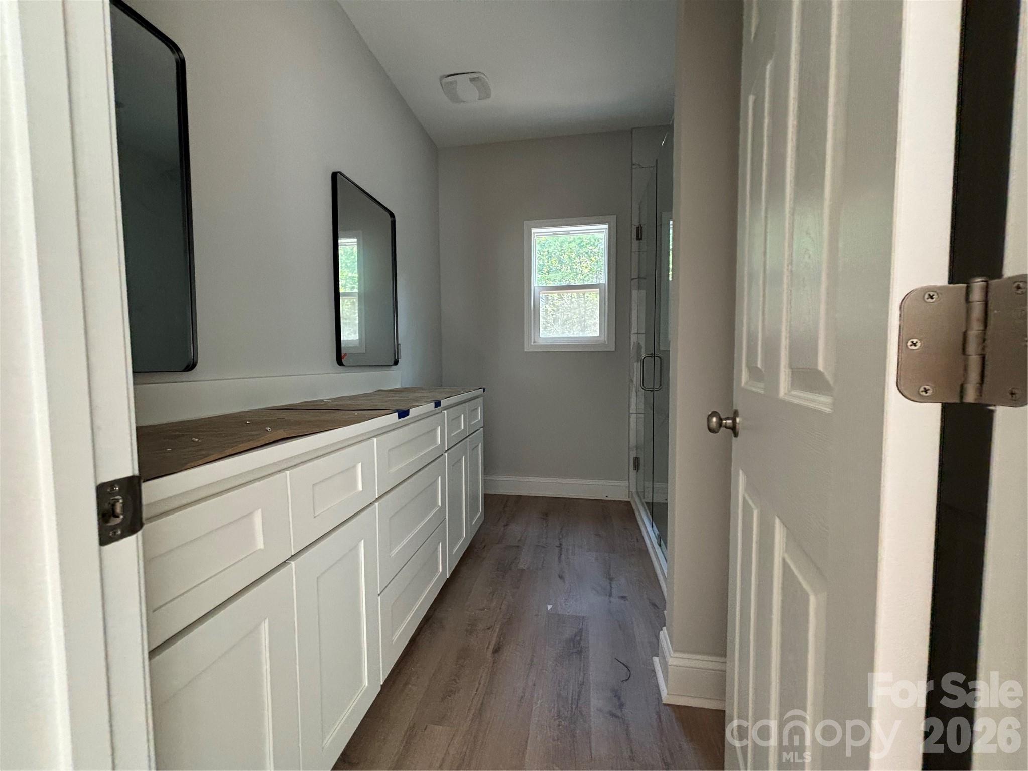 1818 New Salem Road Monroe, NC 28110 - Photo 7 of 8 a bathroom with a sink a mirror and a shower