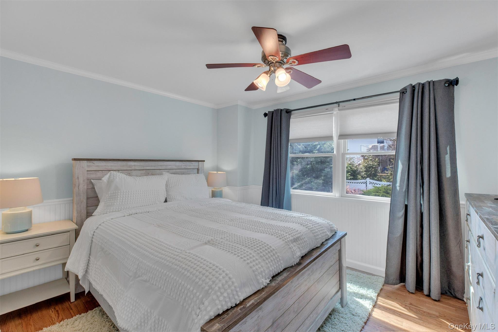 345 Colonial Road Southold, NY 11971 - Photo 28 of 43 a bedroom with a large bed and a window