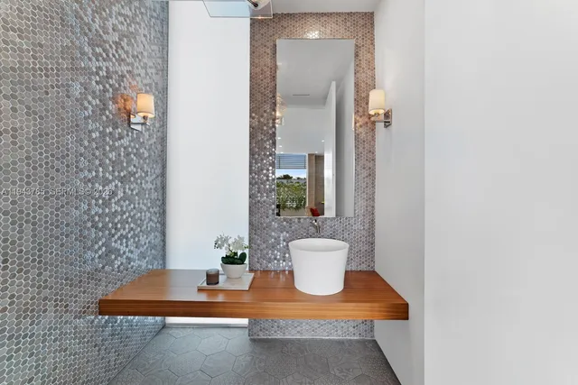a view of a bathroom with a sink and a mirror