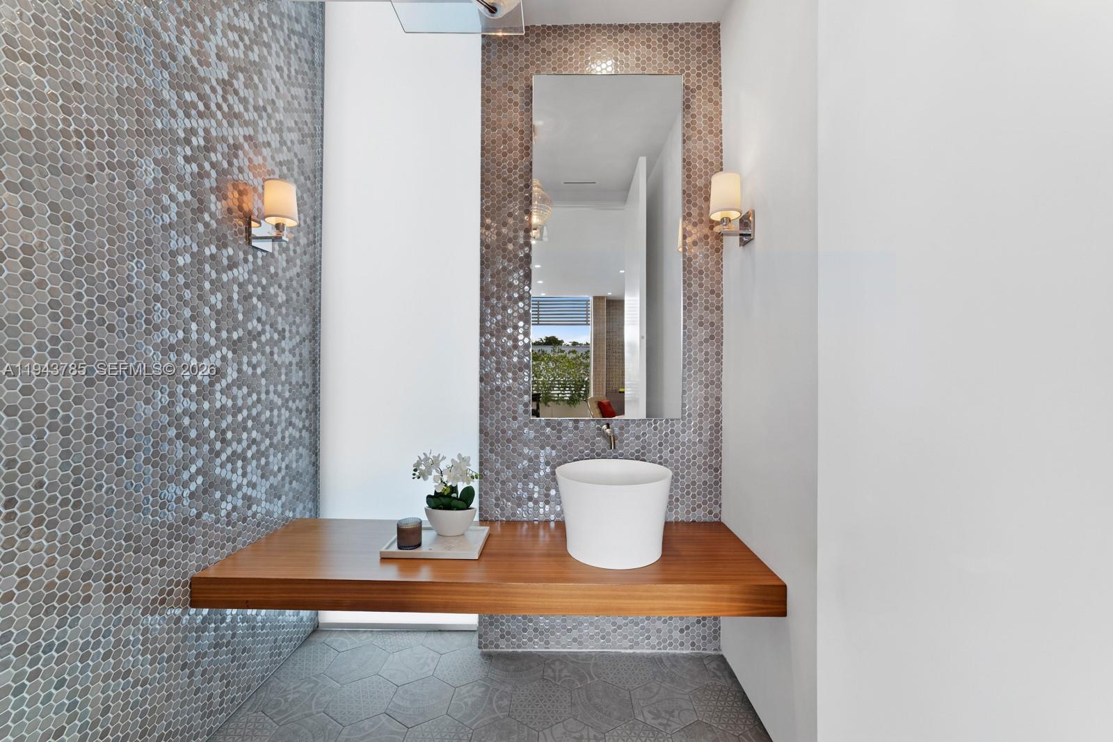 819 2nd Street Miami Beach, FL 33139 - Photo 13 of 32 a view of a bathroom with a sink and a mirror