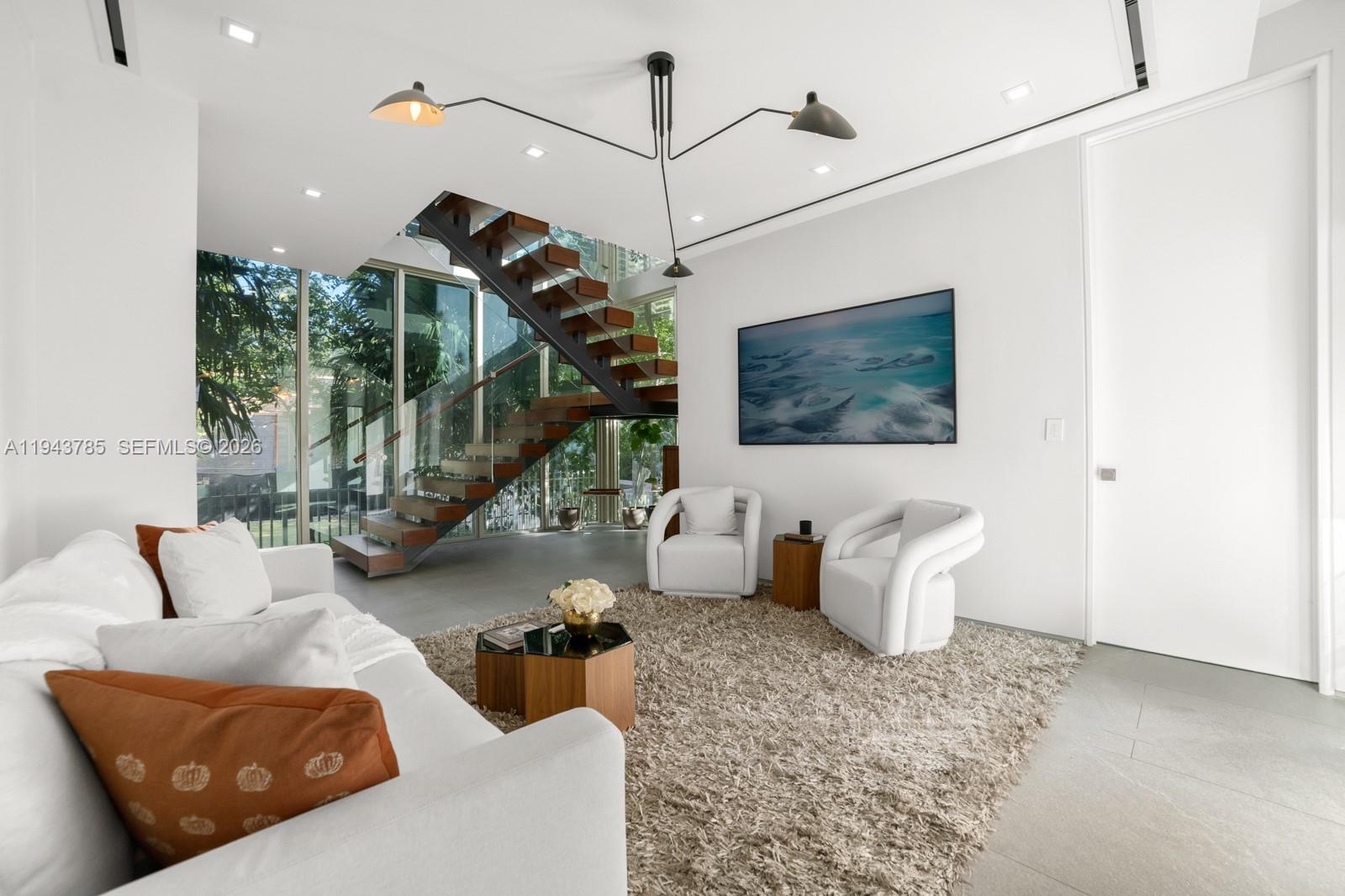 819 2nd Street Miami Beach, FL 33139 - Photo 14 of 32 a living room with furniture and a flat screen tv