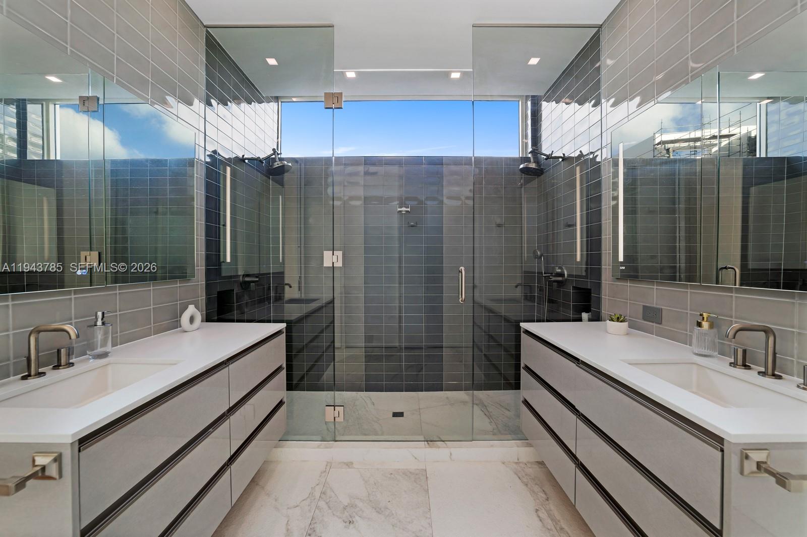 819 2nd Street Miami Beach, FL 33139 - Photo 18 of 32 a bathroom with double vanity and a shower