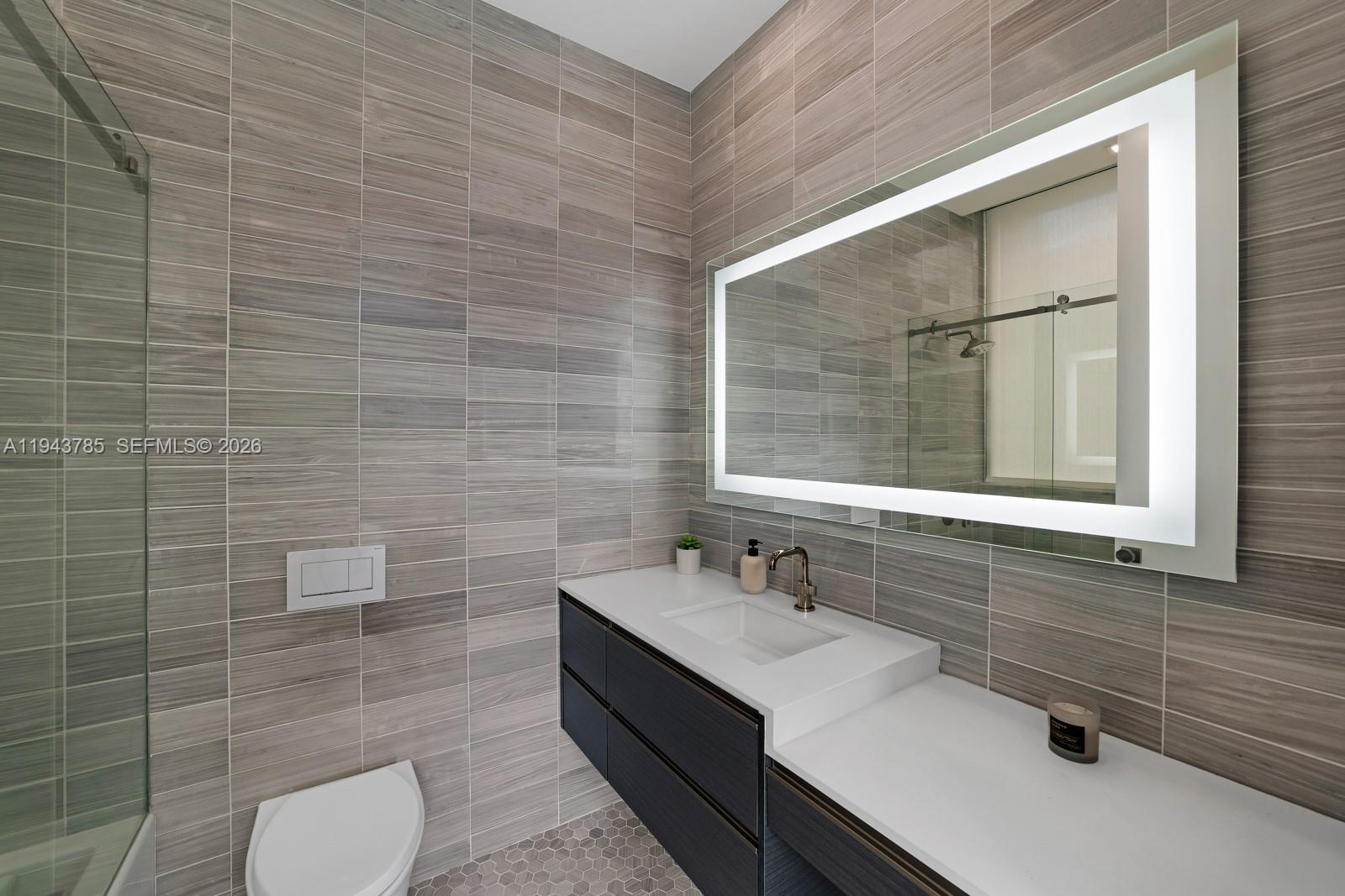 819 2nd Street Miami Beach, FL 33139 - Photo 22 of 32 a bathroom with a sink and a mirror