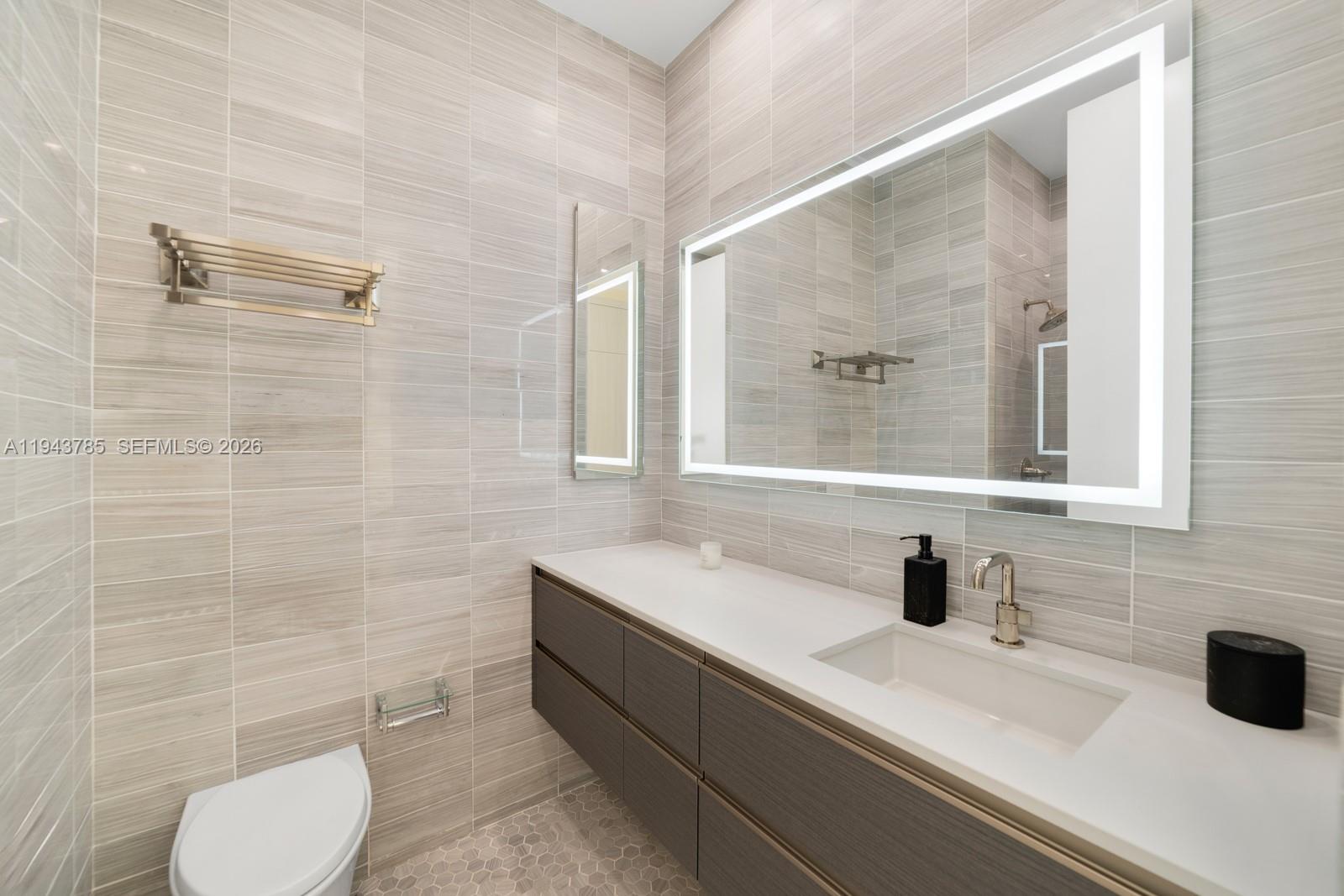 819 2nd Street Miami Beach, FL 33139 - Photo 24 of 32 a bathroom with a sink and a mirror