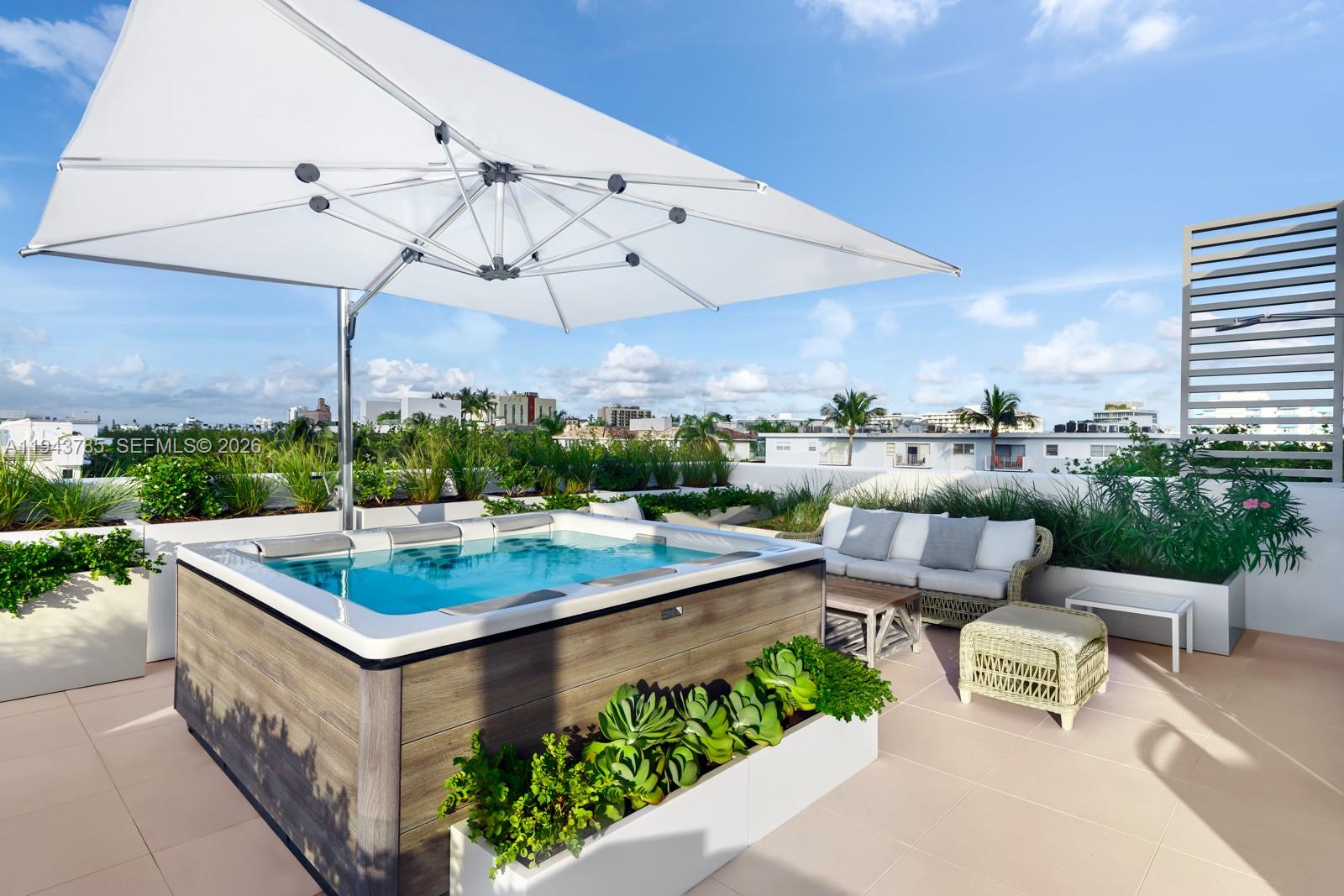 819 2nd Street Miami Beach, FL 33139 - Photo 30 of 32 a view of a patio with a table and chairs