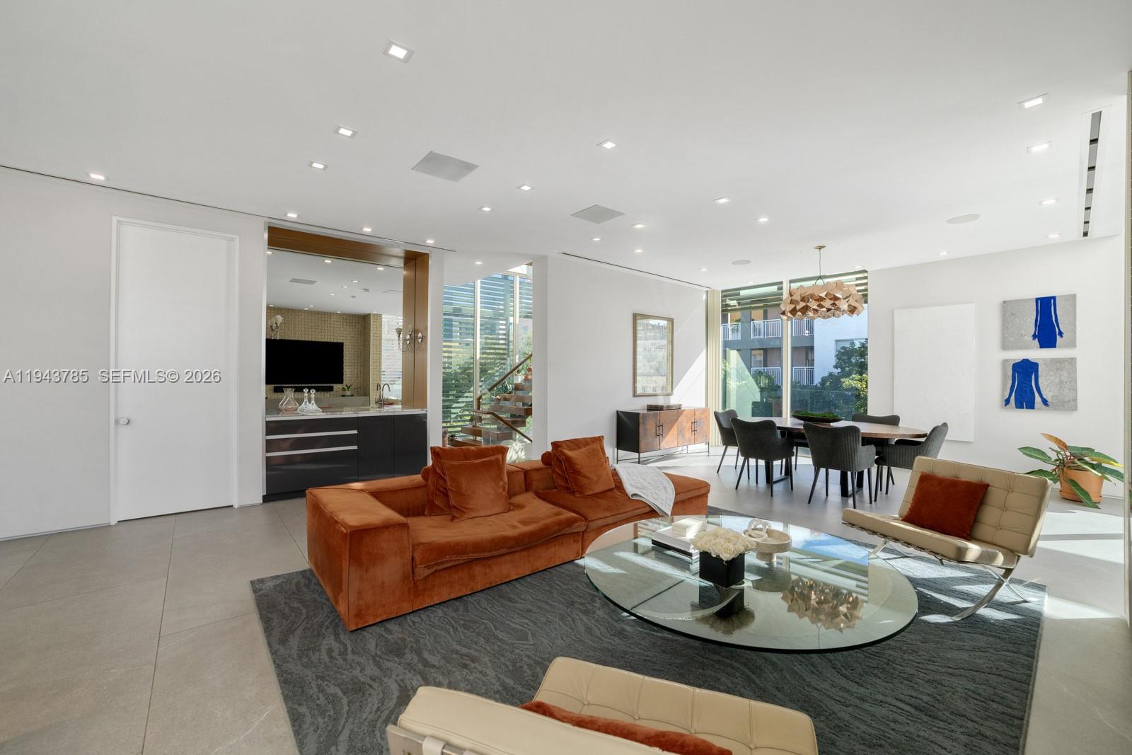 819 2nd Street Miami Beach, FL 33139 - Photo 6 of 32 a living room with furniture kitchen view and a large window