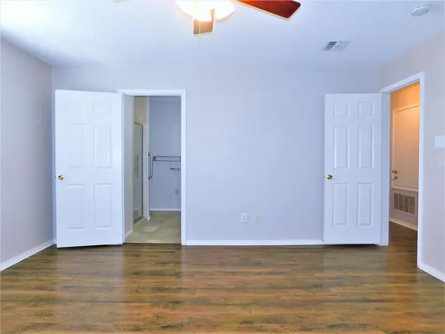 a view of a room with wooden floor