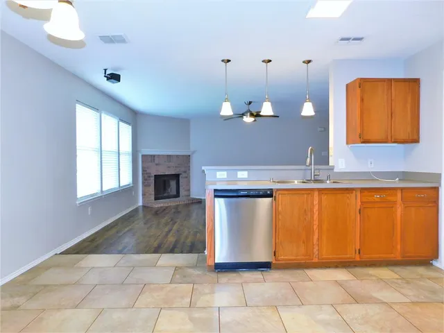 a view of a kitchen with a sink cabinet and a fireplace