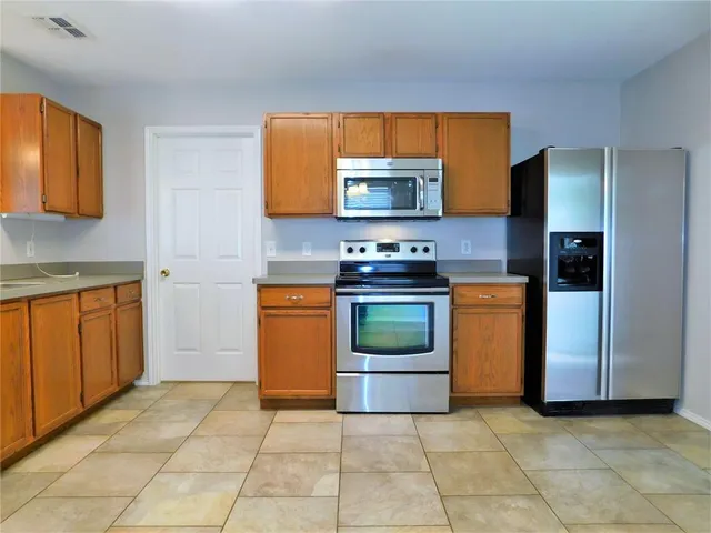 a kitchen with a sink and a stove top oven