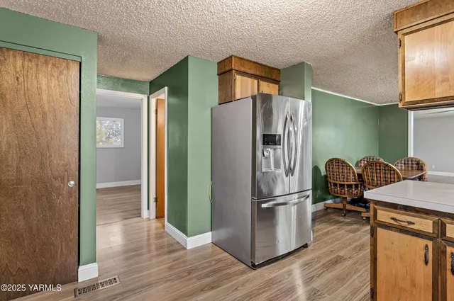 a kitchen with stainless steel appliances granite countertop a refrigerator and a stove top oven