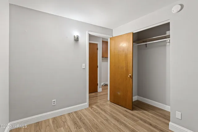 a view of room with wooden floor and window